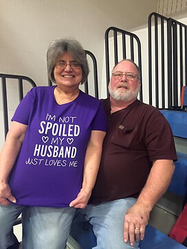 Here we are at a basketball game with my T shirt that says I am not spoiled my husband loves me