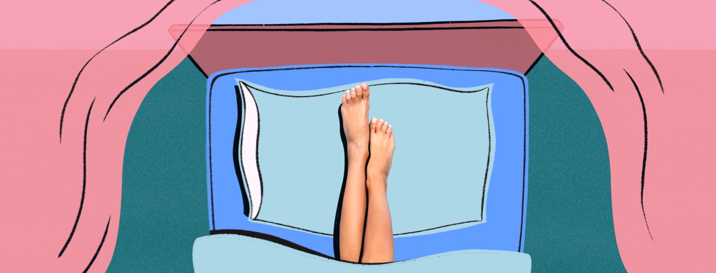 Feet rest on a pillow in bed surrounded by curtains