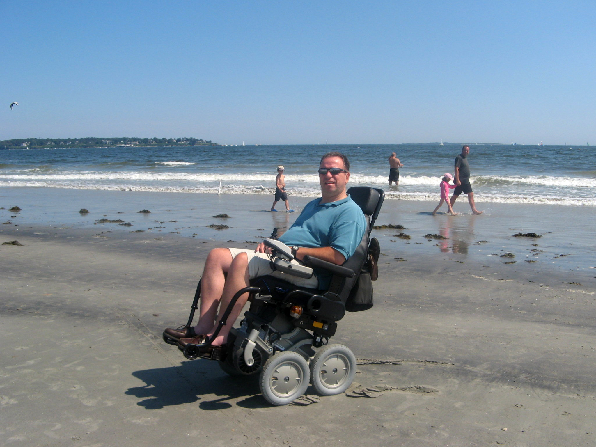 Mitch on a beach in his iBot wheelchair