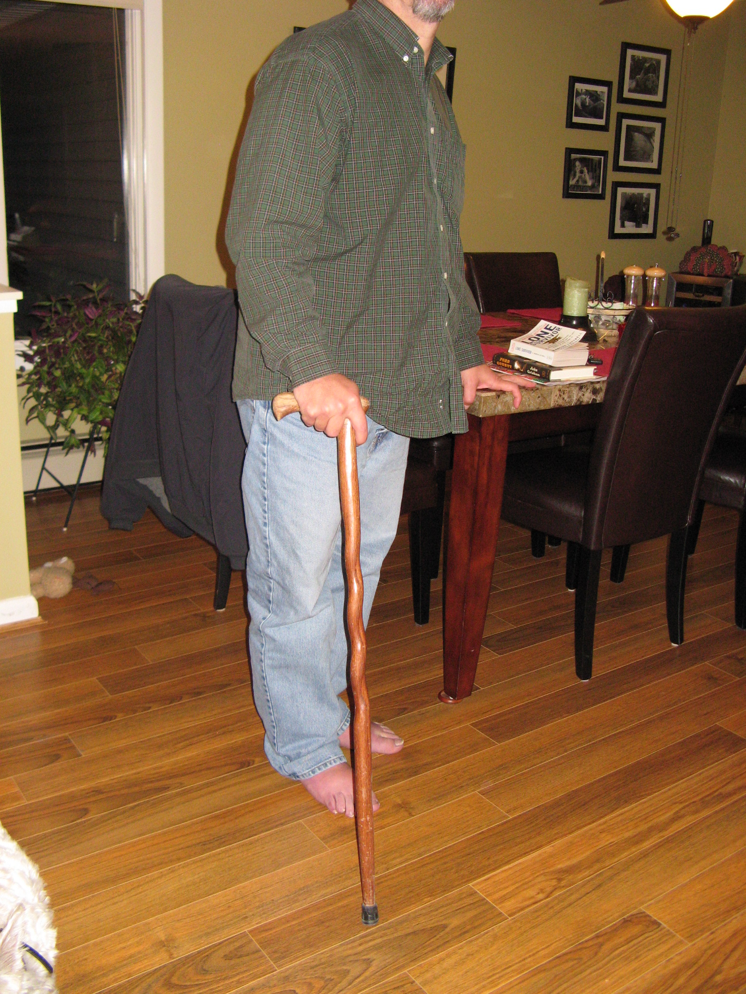 Mitch standing with his wooden cane