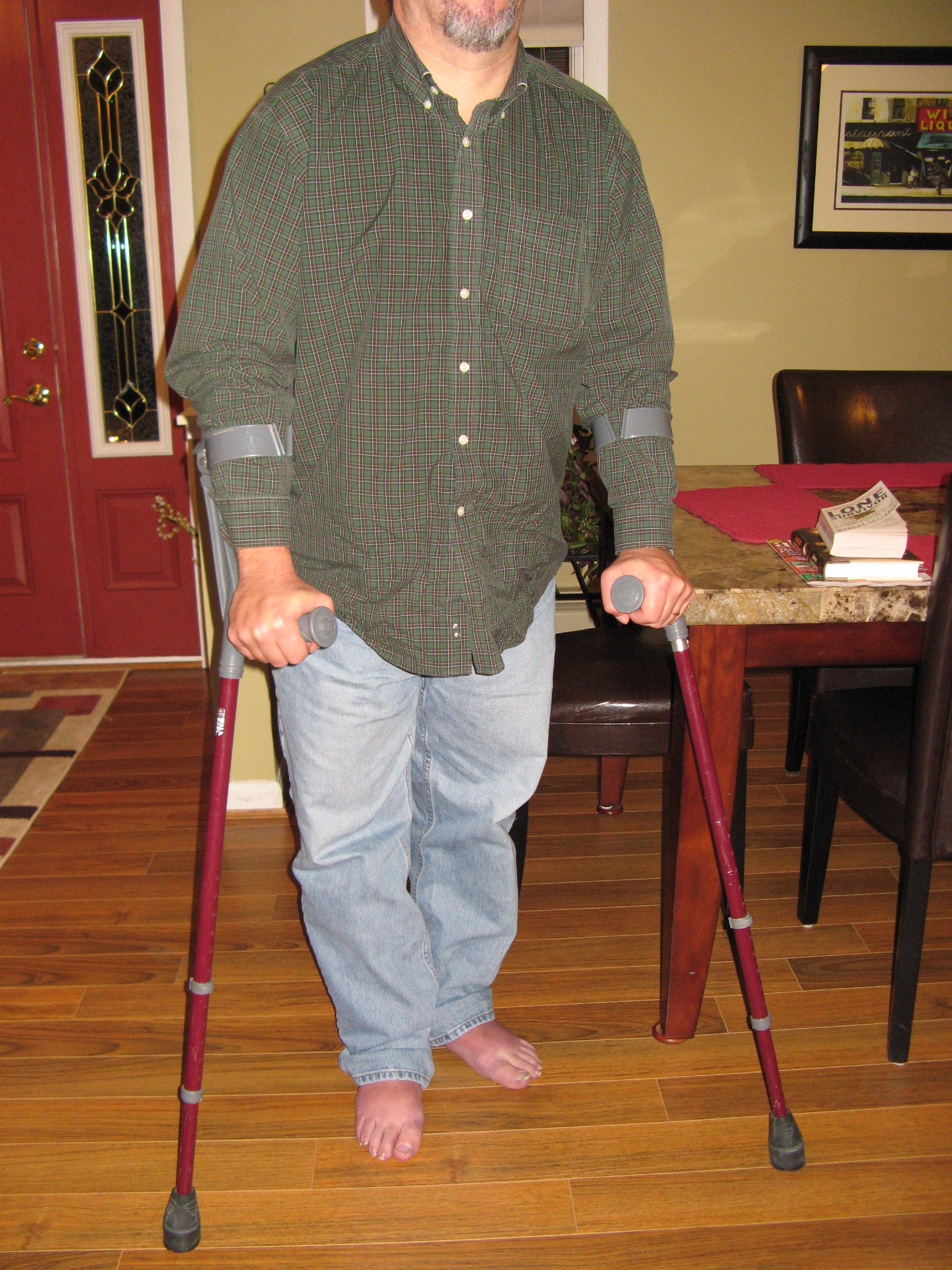 Mitch standing with his forearm crutches