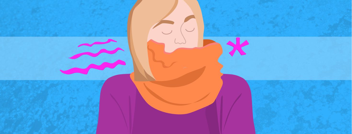 A woman with her entire neck and mouth covered in an orange scarf.