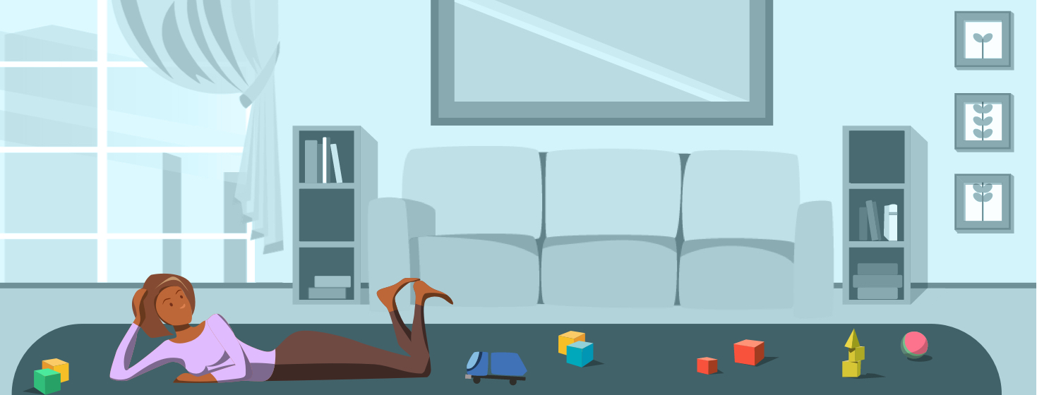 A tired woman lying on the floor surrounded by toys.