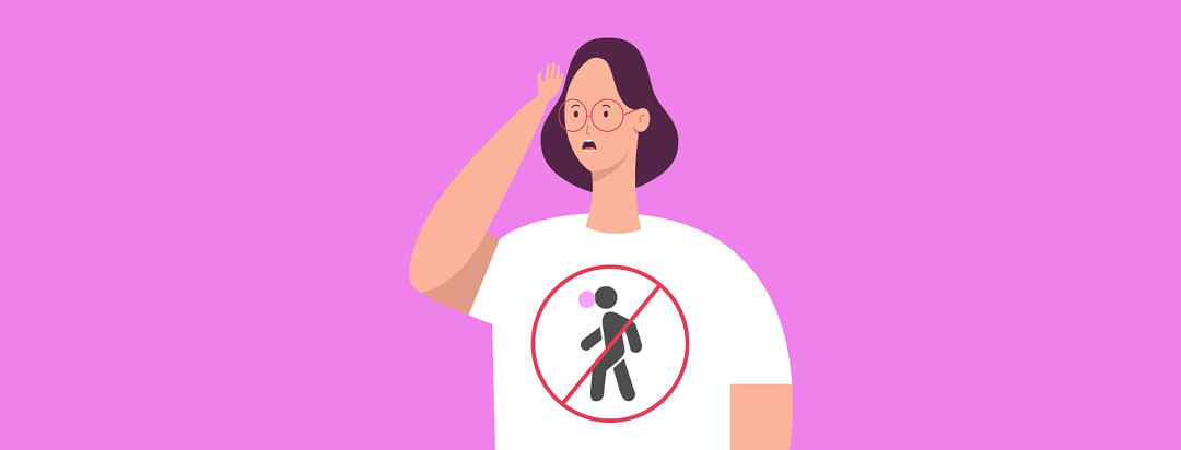 A forgetful person with their hand on their head trying to remember something. They are wearing a shirt with a big "x" through a person walking and chewing gum at the same time.