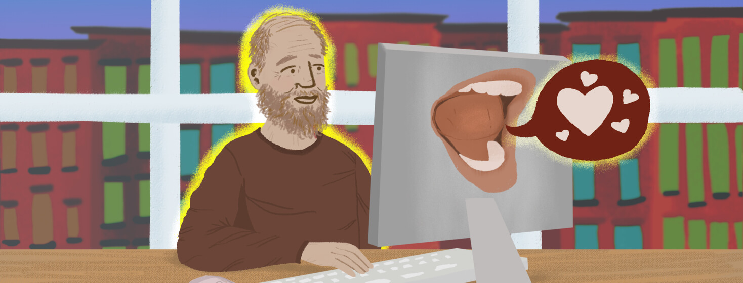 Older person with beard typing on desktop computer; mouth on back of computer relays a talk bubble with hearts in it.