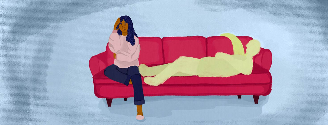 A woman is sitting on a couch next to a shadowy outline of herself laying down. She looks exhausted and annoyed.