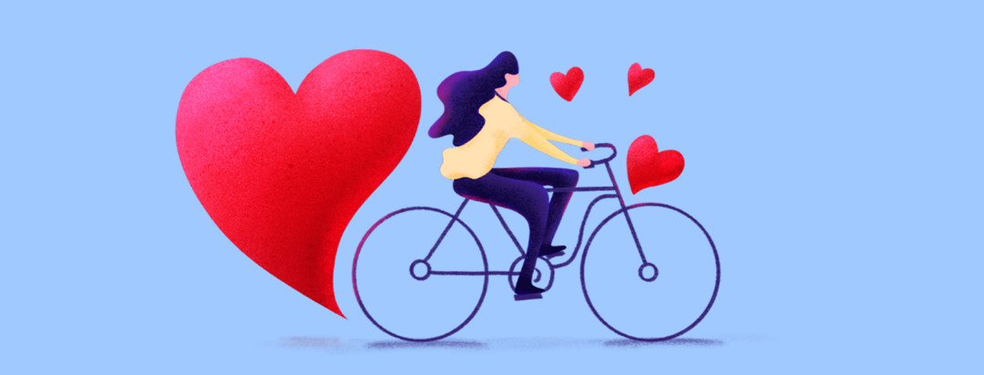 A woman is riding a bike with hearts flying up around her. There is a large heart coming off her back wheel.