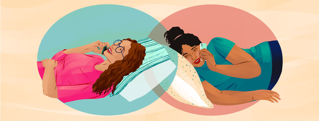 Two women are lying against separate pillows in their own rooms as they talk on the phone to each other. Each is in a separate oval that overlaps in the middle.