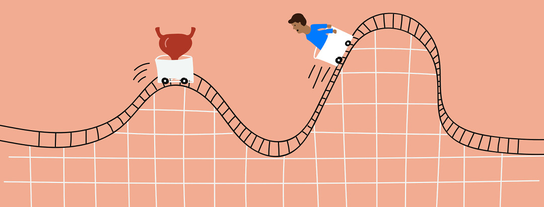 A man in a rollercoaster cart being chased by another cart with a bladder inside it. The track winds up and down.