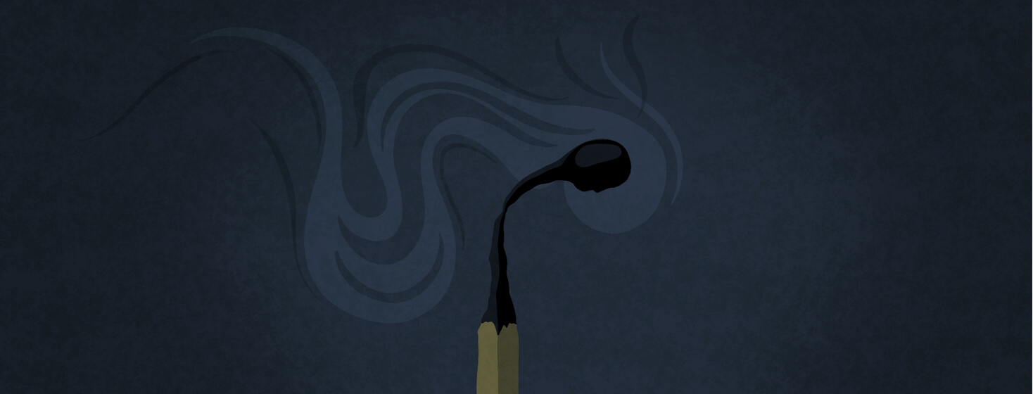 A burnt out and smoking match with a person's profile in the match head.