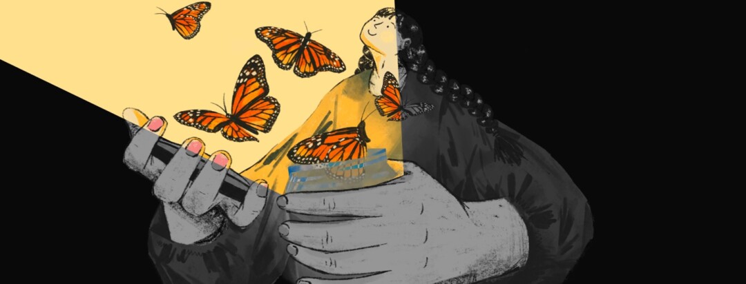 A woman in the dark peacefully watches monarch butterflies fly from a glowing open jar