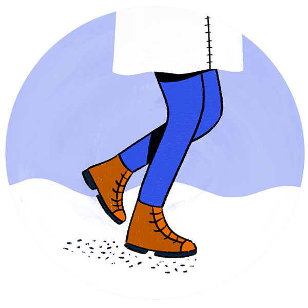 A pair of legs in winter gear walking in the snow with ice melt on the floor 