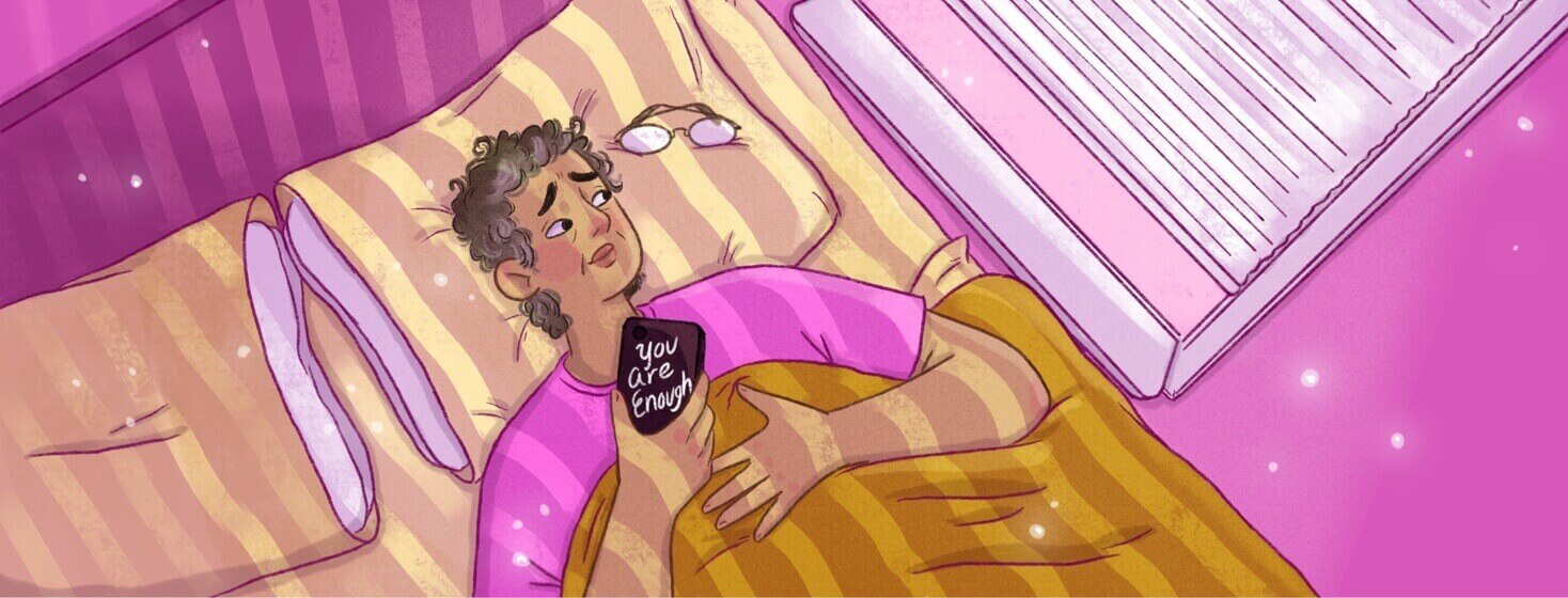 A woman lays in bed with the sun shining through the blinds, she holds her phone to her chest, the case says "You Are Enough" on it