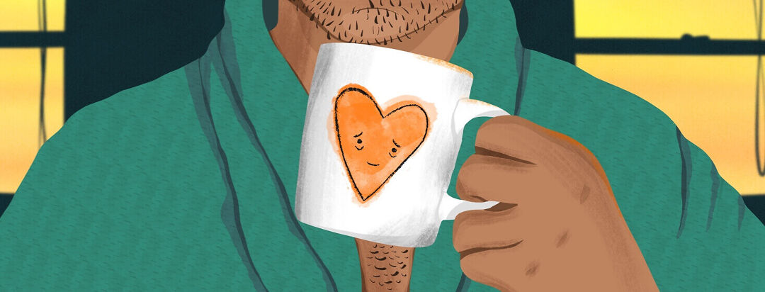 A man in a robe holds a coffee mug with an exhausted heart on it